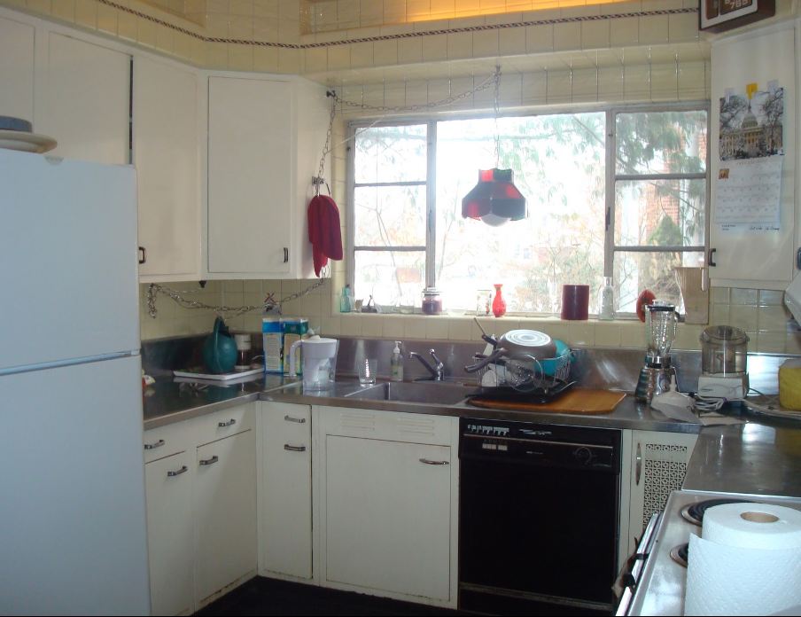 A kitchen with a sink and a refrigerator