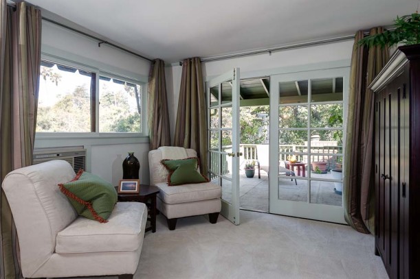 A view of a living room filled with furniture and a large window