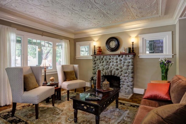 A living room filled with furniture and a stone fire place