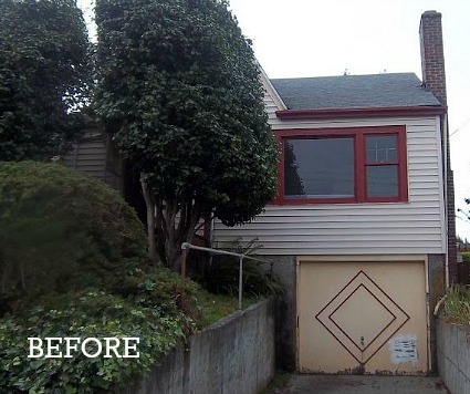 small house obscured by overgrown bushes