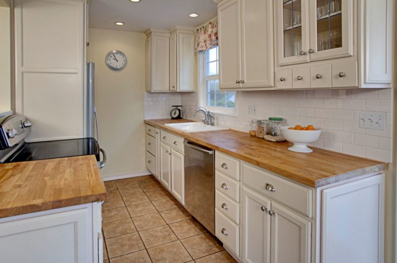 A kitchen with a sink and a microwave