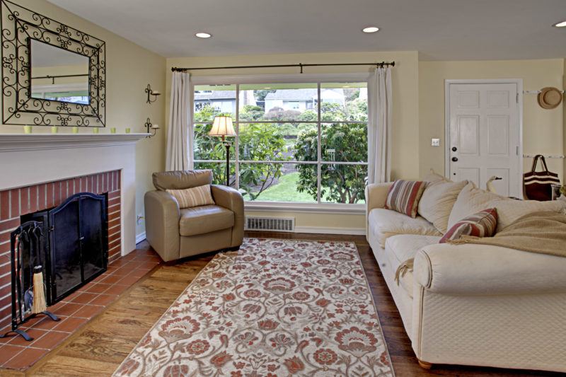 A view of a living room filled with furniture and a fire place