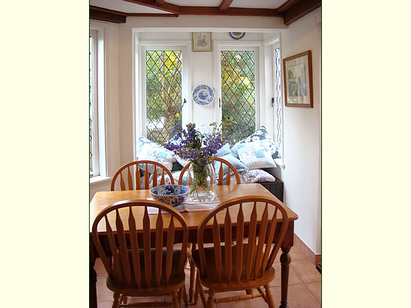 A dining room table in front of a window