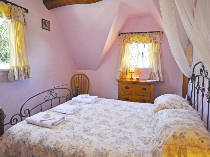 cottage bedroom with iron headboard