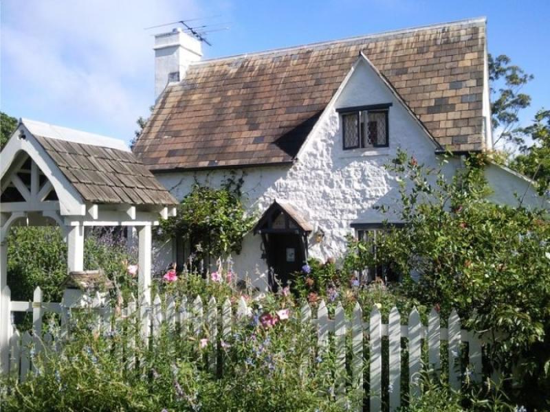 Fig Tree Cottage with white picket fence and cottage garden