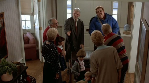 A group of people standing in the entry hall