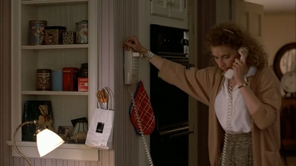 woman talking on phone in kitchen