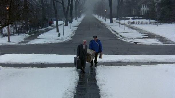 Steve Martin and John Candy walking up to house on snowy day