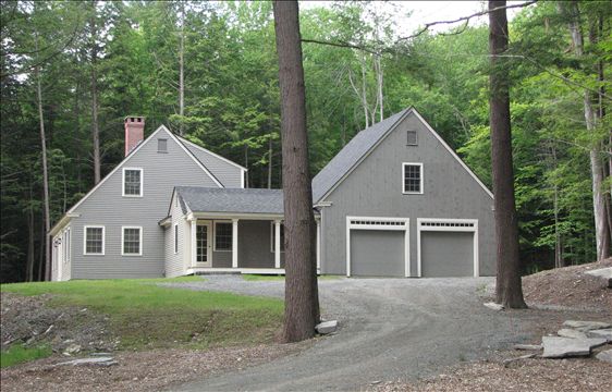 side exterior view of Cape with two car garage and porch