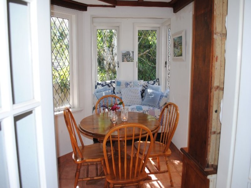 A round dining room table in front of a window