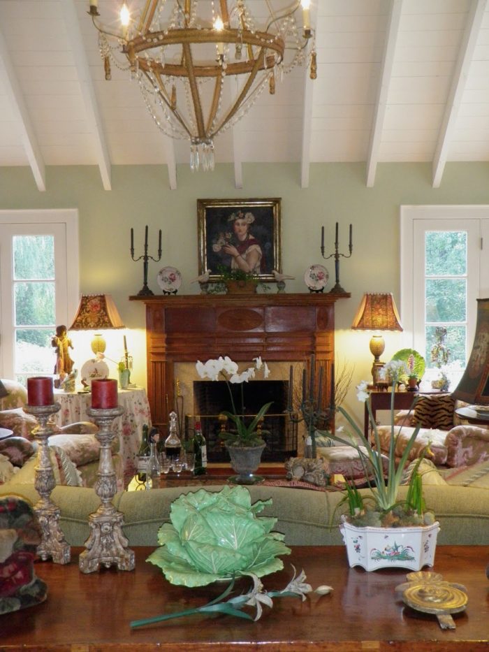 A room filled with furniture and vase of flowers on a table