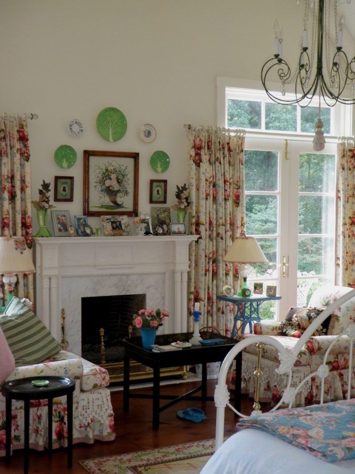 bedroom with fireplace and decorative plates on wall