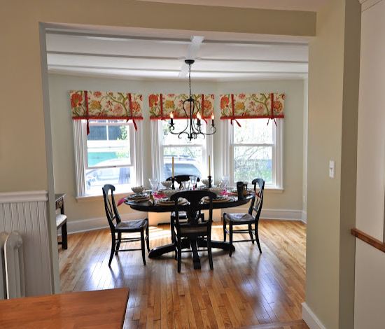 A dining room table in front of a window