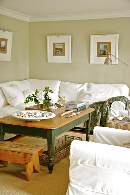 A living room with white slipcovered furniture