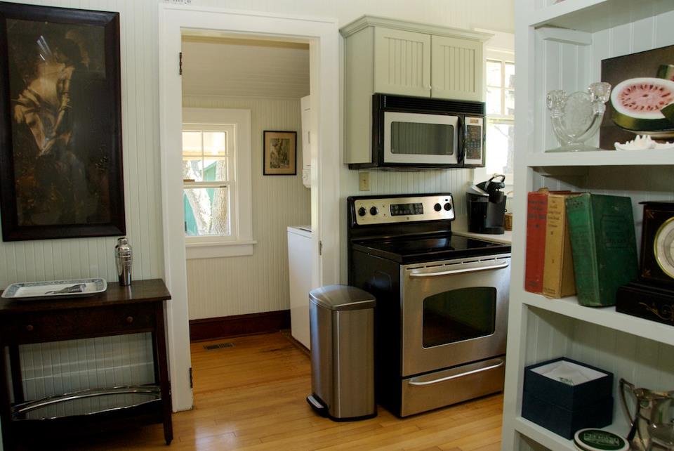 A kitchen with a stove top oven sitting inside of a room