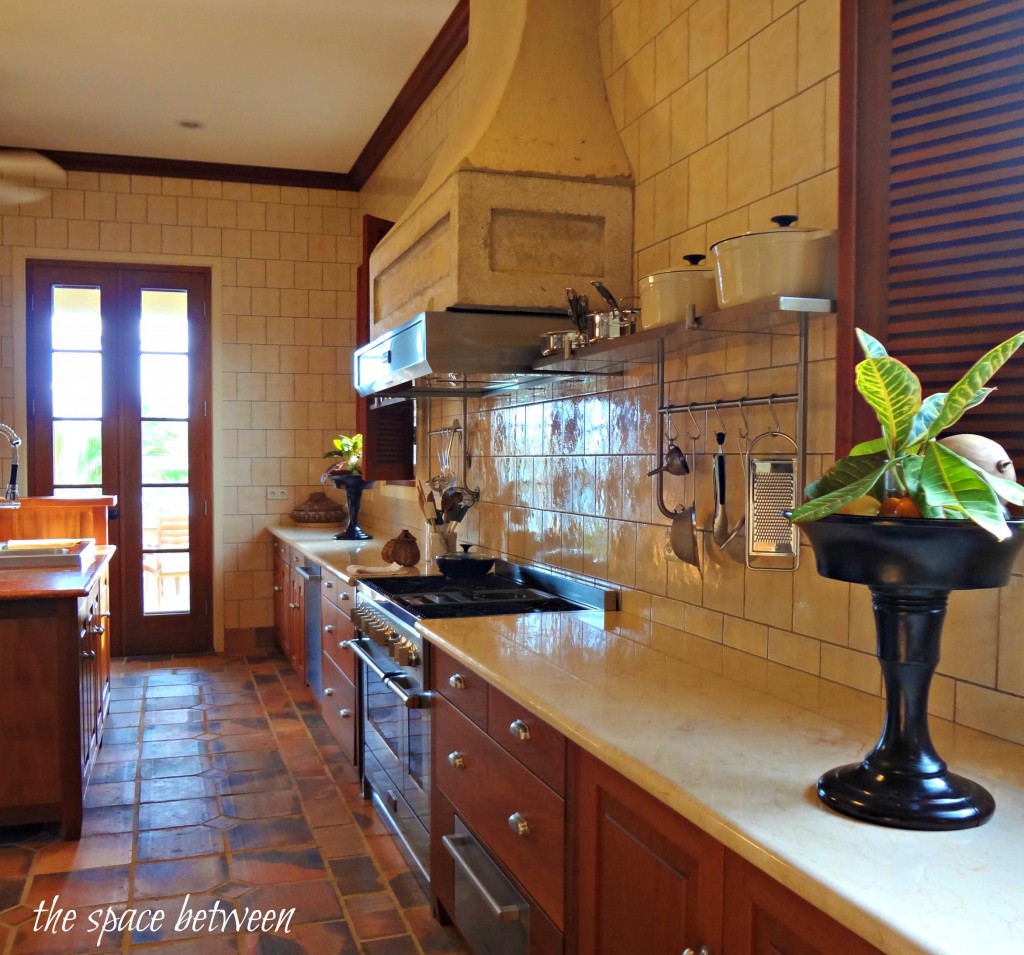 kitchen with large vent hood over range 