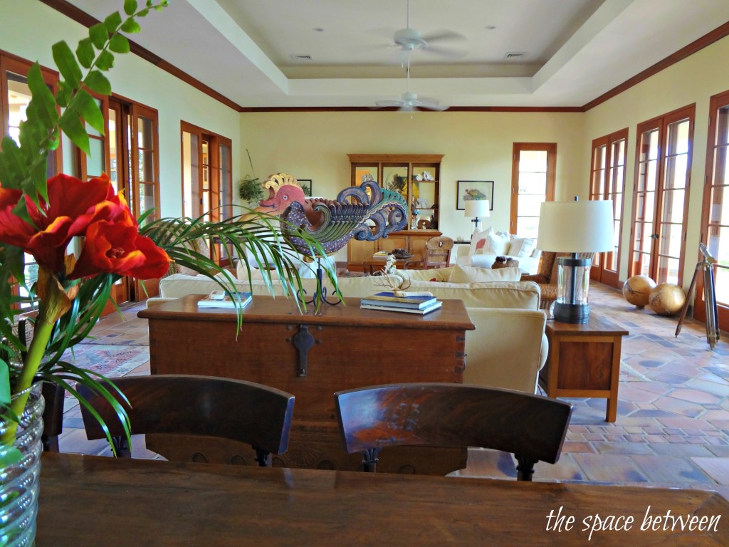 A room filled with furniture and vase of flowers on a table