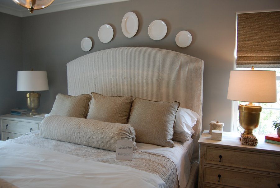 A large bed with decorative plates hung over the headboard