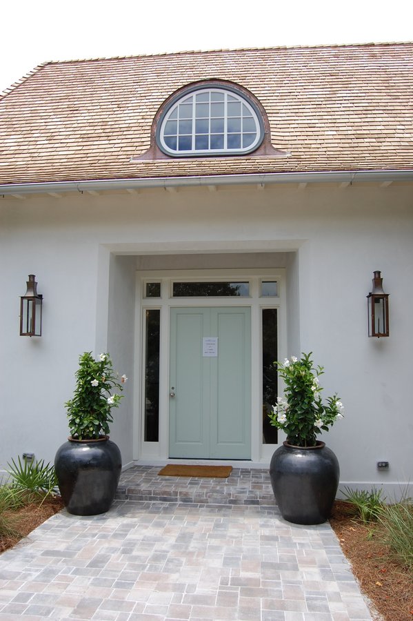 front door of beach house painted aqua blue