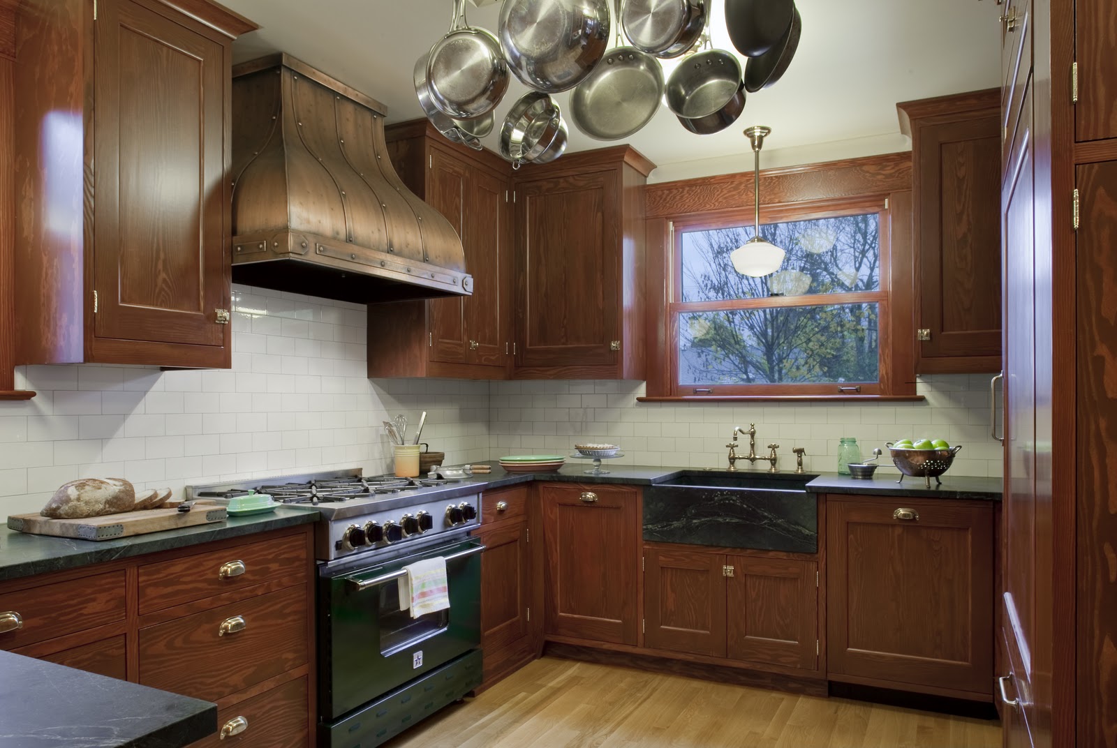 A kitchen with stainless steel appliances and wooden cabinets