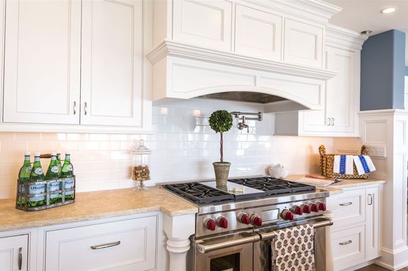 A kitchen with a stove top oven sitting next to a window