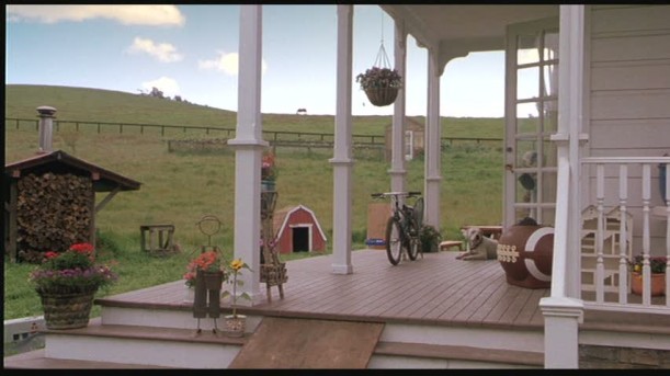 front porch of farmhouse with bike sitting on it