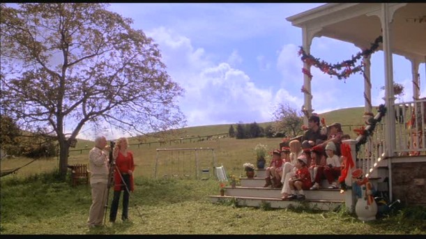 family gathering on front steps of farmhouse 