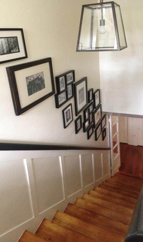 looking down staircase with framed family photos