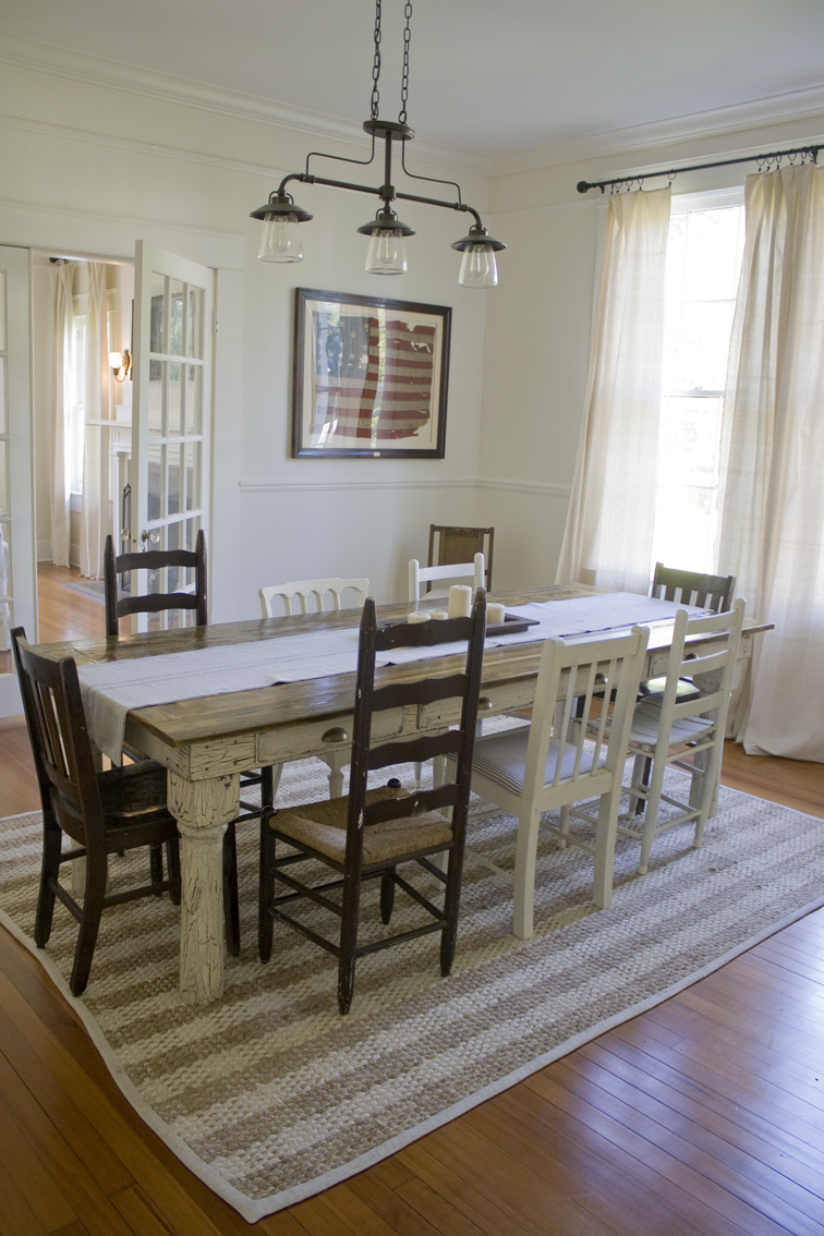 A dining room table in front of a window