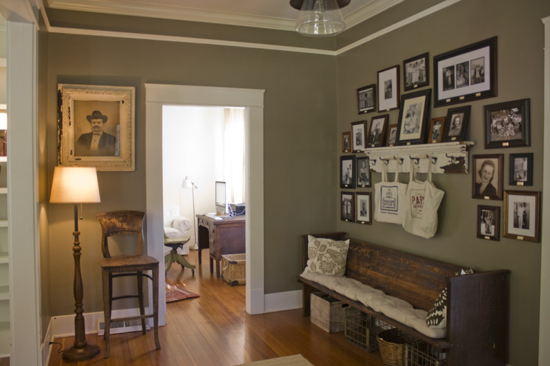 entry hall with bench and family photos in Erin and Ben Napier\'s Craftsman cottage