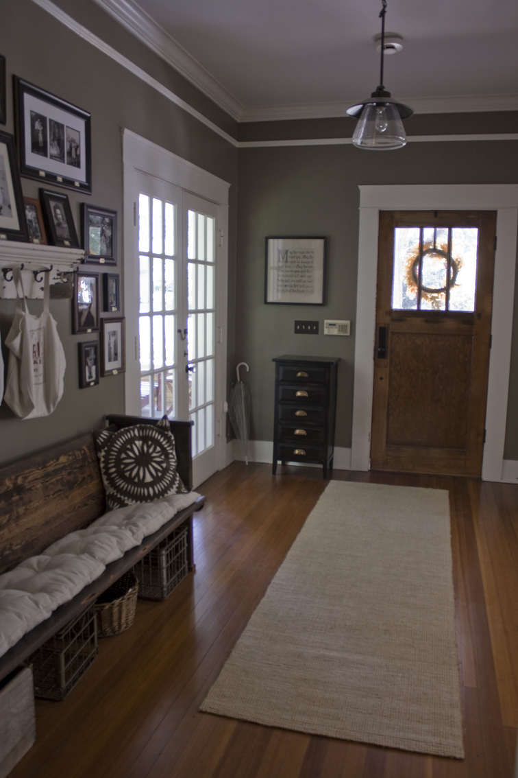 entry door and church pew in Erin and Ben Napier\'s Craftsman cottage