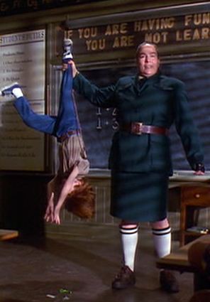 Miss Trunchbull holds student upside down by his leg