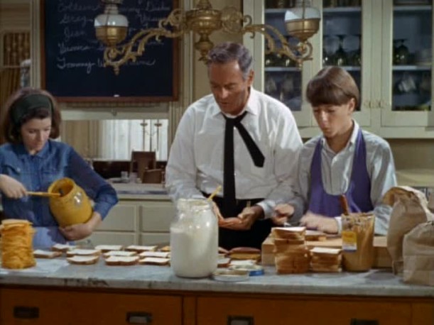 Henry Fonda making lunches in the kitchen for family