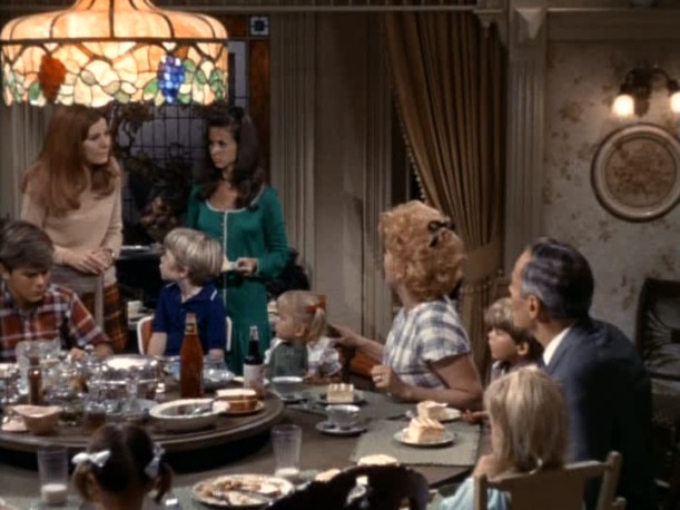 family sitting around dining table