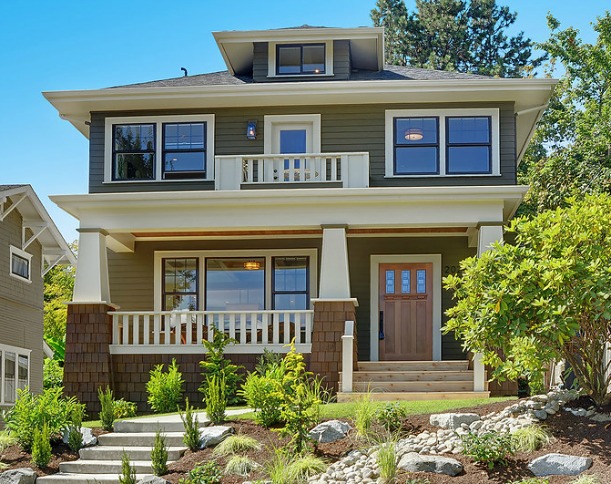 front exterior of newly remodeled bungalow with new porch and balcony