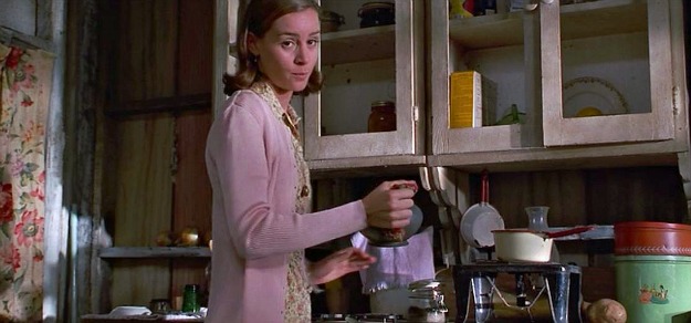 Miss Honey pouring tea in her cottage kitchen