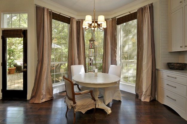 round dining table with chairs in bay window