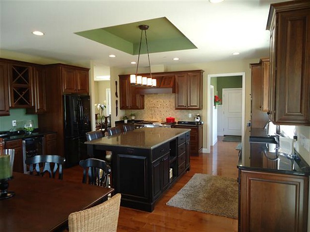 A large kitchen with an island in the middle of a room
