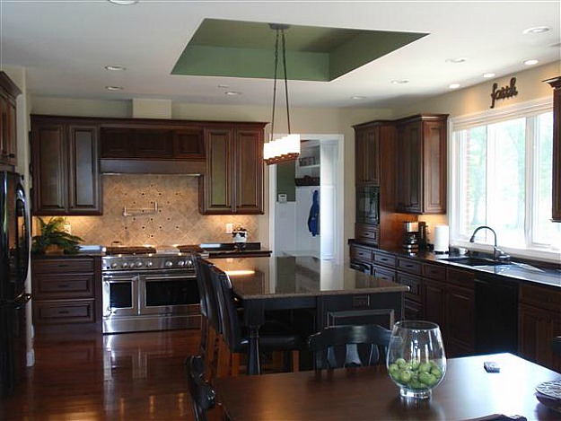 A kitchen with an island in the middle of a room