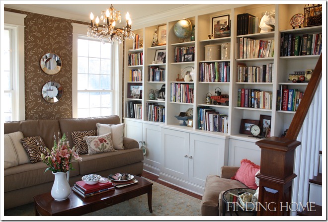 A living room filled with furniture and a book shelf