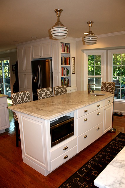 A kitchen with an island in the middle of a room