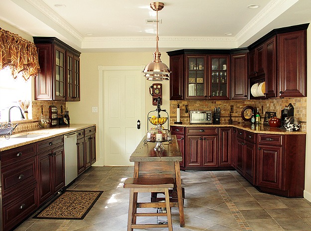 A large kitchen with stainless steel appliances and wooden cabinets