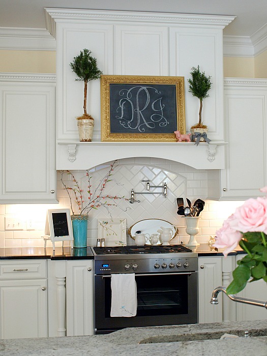 A kitchen with vent hood shelf over range