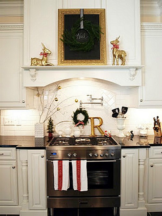 A kitchen with a stove top oven decorated for Christmas