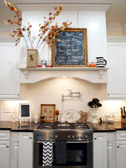 A kitchen range with shelf decorated for fall