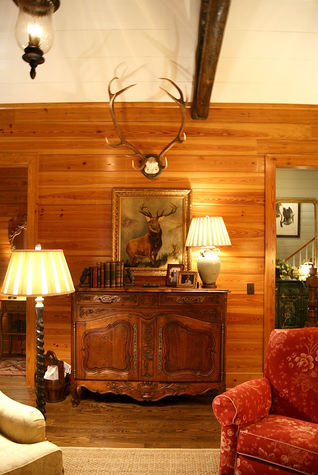 A living room with wood plank walls