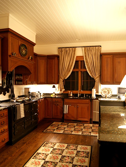 A large kitchen with stainless steel appliances and wooden cabinets