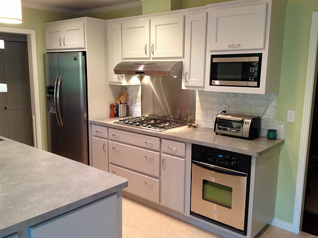 A kitchen with white cabinets