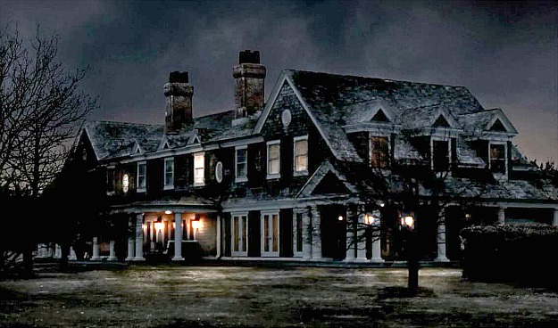 front exterior of Grayson Manor in the snow at night with lights on