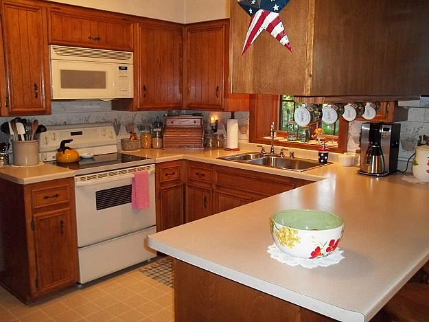 A kitchen with stainless steel appliances and wooden cabinets